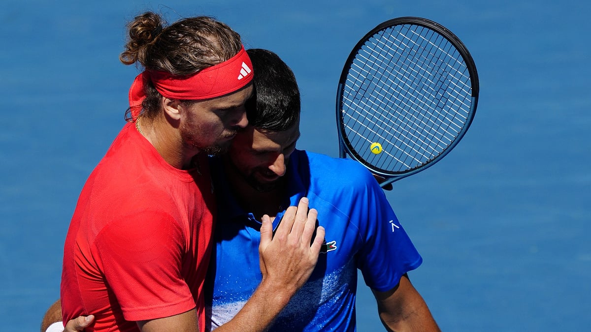 Alexander Zverev comforts Novak Djokovic