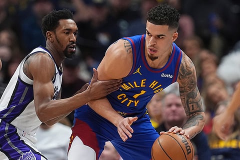 NBA Basketball 2024-25: Nuggets Michael Porter Jr. picks up the ball as Kings Malik Monk defends