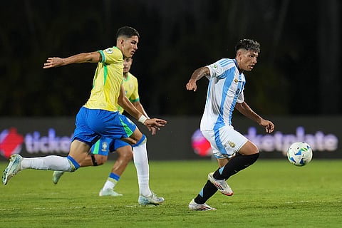 U-20 South American Championship: Brazil's Jair, left, chases Argentina's Agustin Ruberto for control of the ball 