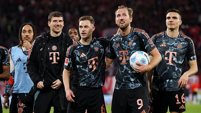Bayern Munich players celebrate their win away to Freiburg, led by Harry Kane and Joshua Kimmich. - null
