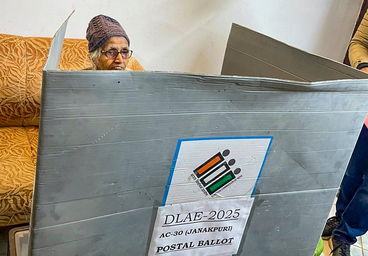 PTI : In this image via @ECISVEEP on X on Jan. 24, 2025, a senior citizen castes her vote for Delhi Assembly elections through the home voting facility made available for the elderly and people with disabilities, at her residence, in New Delhi. 