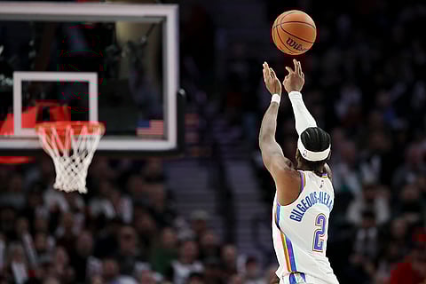 NBA 2024-25: Thunder guard Shai Gilgeous-Alexander (2) shoots against the Portland Trail Blazers