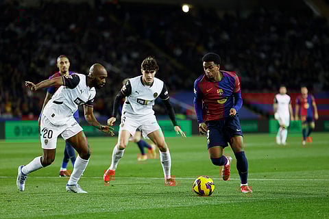 La Liga 2024-25: Barcelona's Alejandro Balde and Valencia's Dimitri Foulquier challenge for the ball