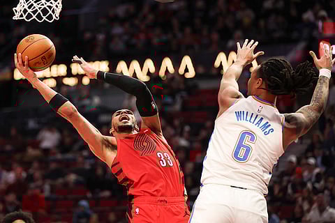 NBA 2024-25: Blazers forward Toumani Camara (33) drives to the basket