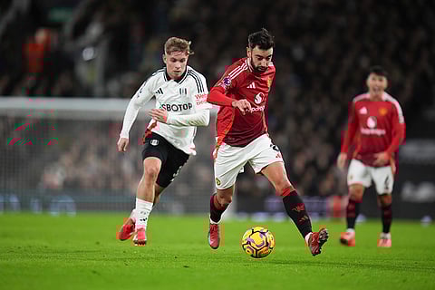 EPL 2024-25: Bruno Fernandes dribbles the ball followed by Fulham's Emile Smith Rowe