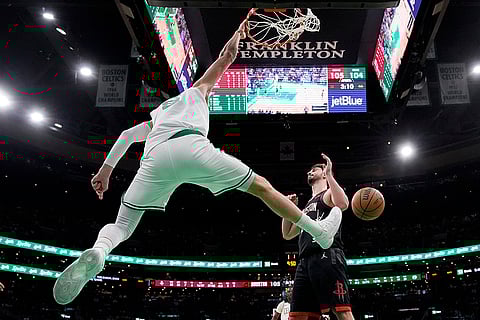 NBA 2024-25: Celtics center Kristaps Porzingis (8) slams a dunk