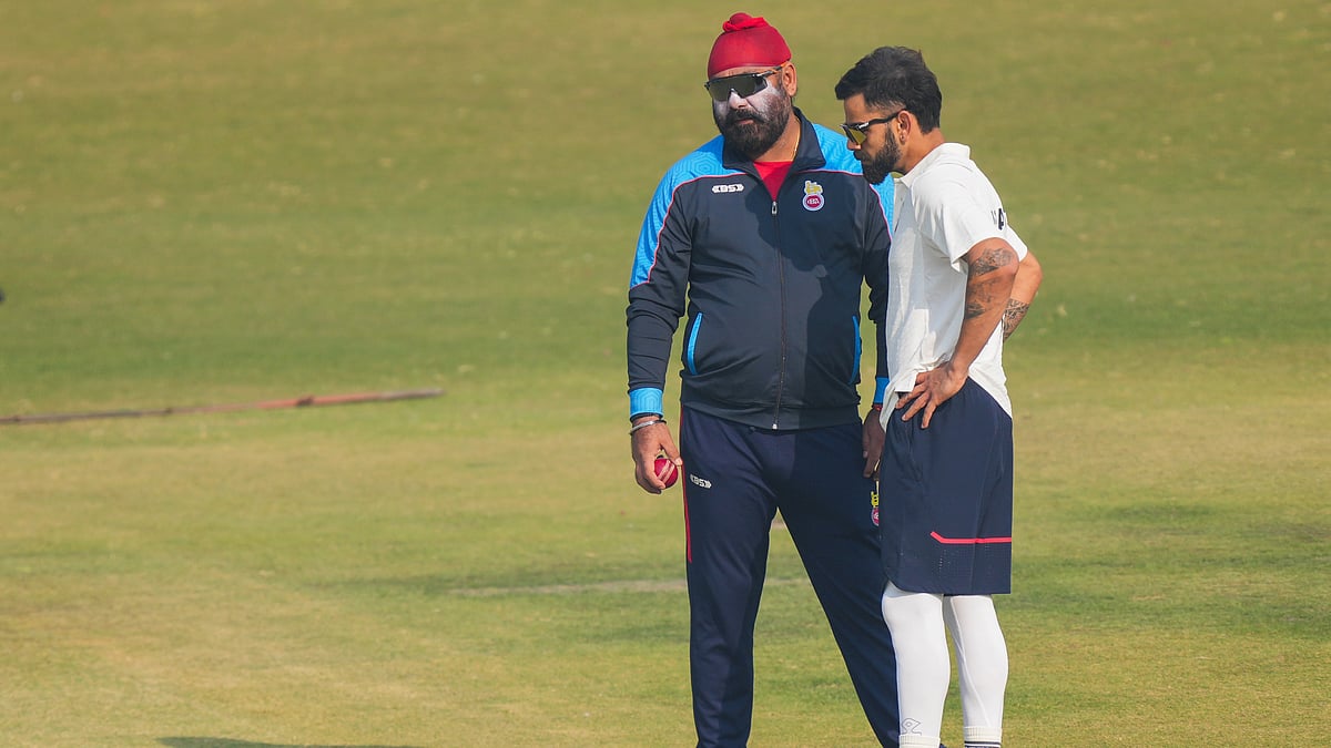 PTI Photo/Kamal Kishore : Delhi's player Virat Kohli with team coach Sarandeep Singh inspects the pitch during a training session ahead of the Ranji Trophy 2024-25 cricket match between Delhi and Railways, at the Arun Jaitley Stadium.