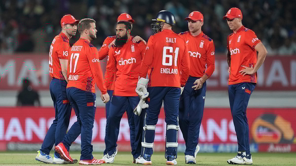  (AP Photo/Ajit Solanki) : England's Adil Rashid, third left, celebrates with teammates the wicket of India's Tilak Varma during the Twenty20 cricket match between England and India in Rajkot, India, Tuesday, Jan. 28, 2025.