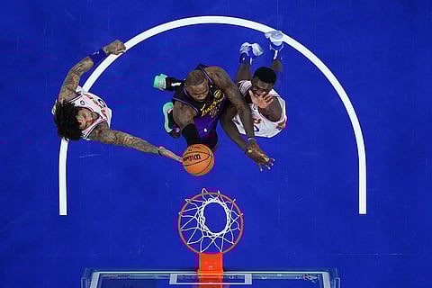 NBA 2024-25: Lakers' LeBron James, center, goes up for a shot