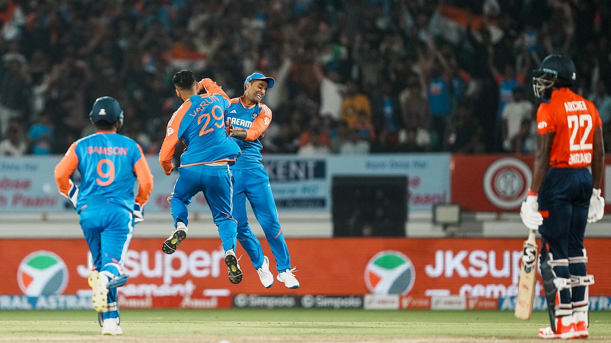 PTI Photo/Kunal Patil : India's Varun Chakravarthy with teammates celebrates the wicket of England's Jofra Archer during the third T20 cricket match between India and England at the Niranjan Shah Stadium in Rajkot.