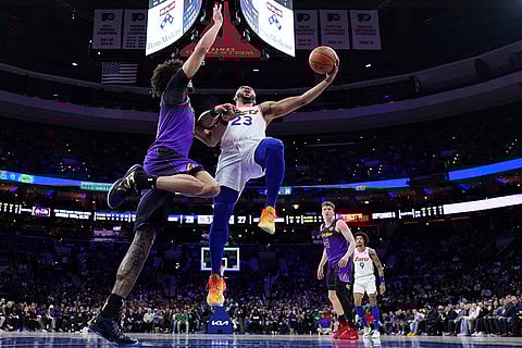 NBA 2024-25: 76ers' Eric Gordon, right, goes up for a shot against Lakers