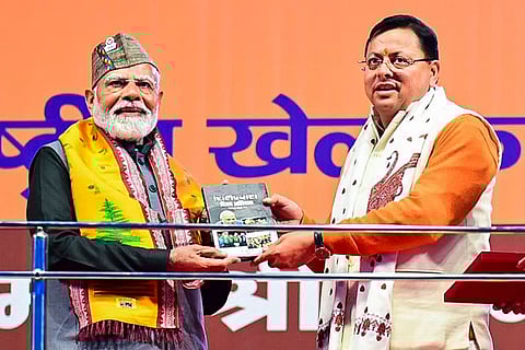PM Narendra Modi being welcomed by Pushkar Singh Dhami