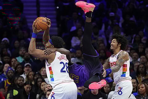 NBA 2024-25: 76ers' Guerschon Yabusele, left, tries to shoot against Lakers' Dorian Finney-Smith