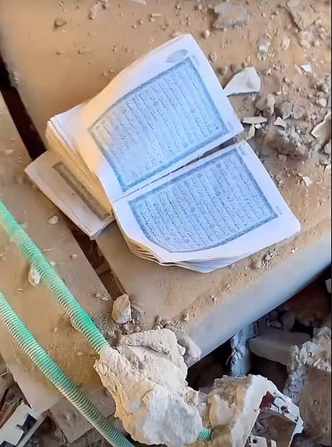 Sanad finds a copy of the Quran lying among the debris