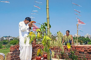 | Photo: shutterstock : Contested Claim: A man worshipping in a Sarna Sthal during Sarhul Pooja in Jharkhand