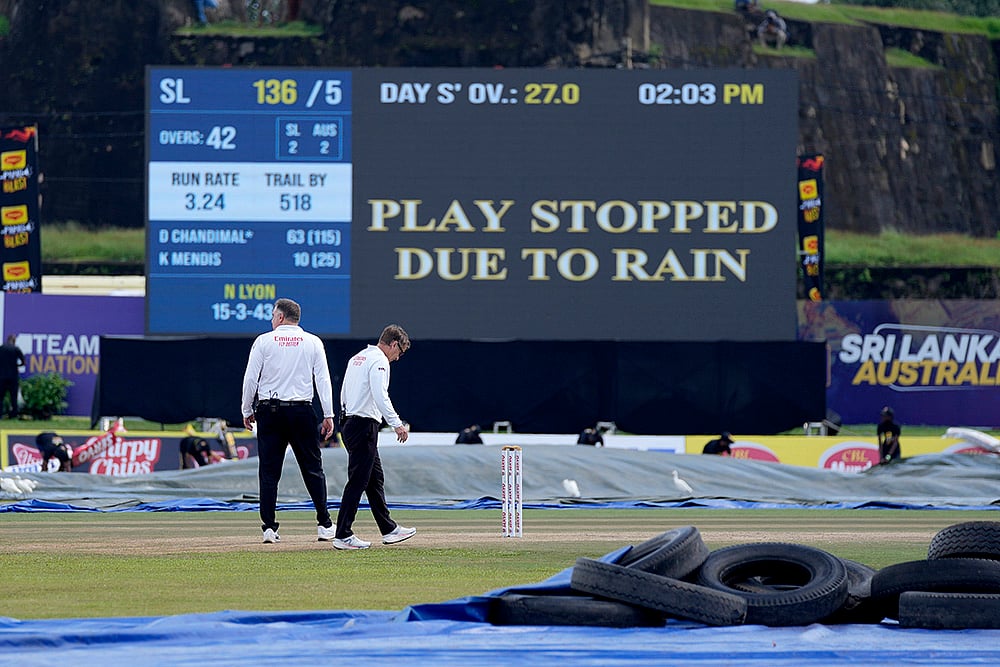 | Photo: AP/Eranga Jayawardena : SL vs AUS 1st Test Day 3: Umpires inspect the ground condition
