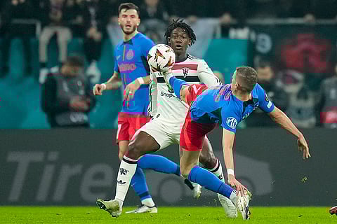 Europa League 2024-25: Man United's Kobbie Mainoo challenges for the ball with FCSB's Florin Tanase