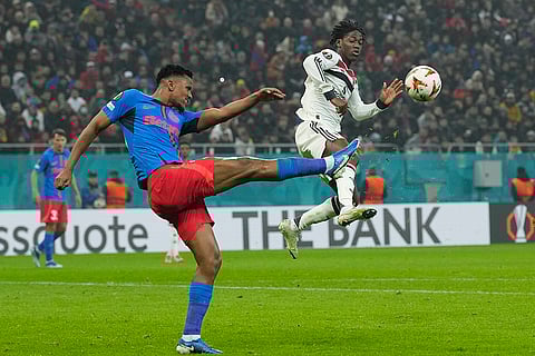 Europa League 2024-25: FCSB's Siyabonga Ngezana clears the ball next to Man United's Kobbie Mainoo