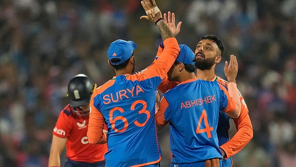 | Photo: AP/Rafiq Maqbool : IND vs ENG 4th T20: India's Varun Chakravarthy celebrates the wicket of England's Brydon Carse