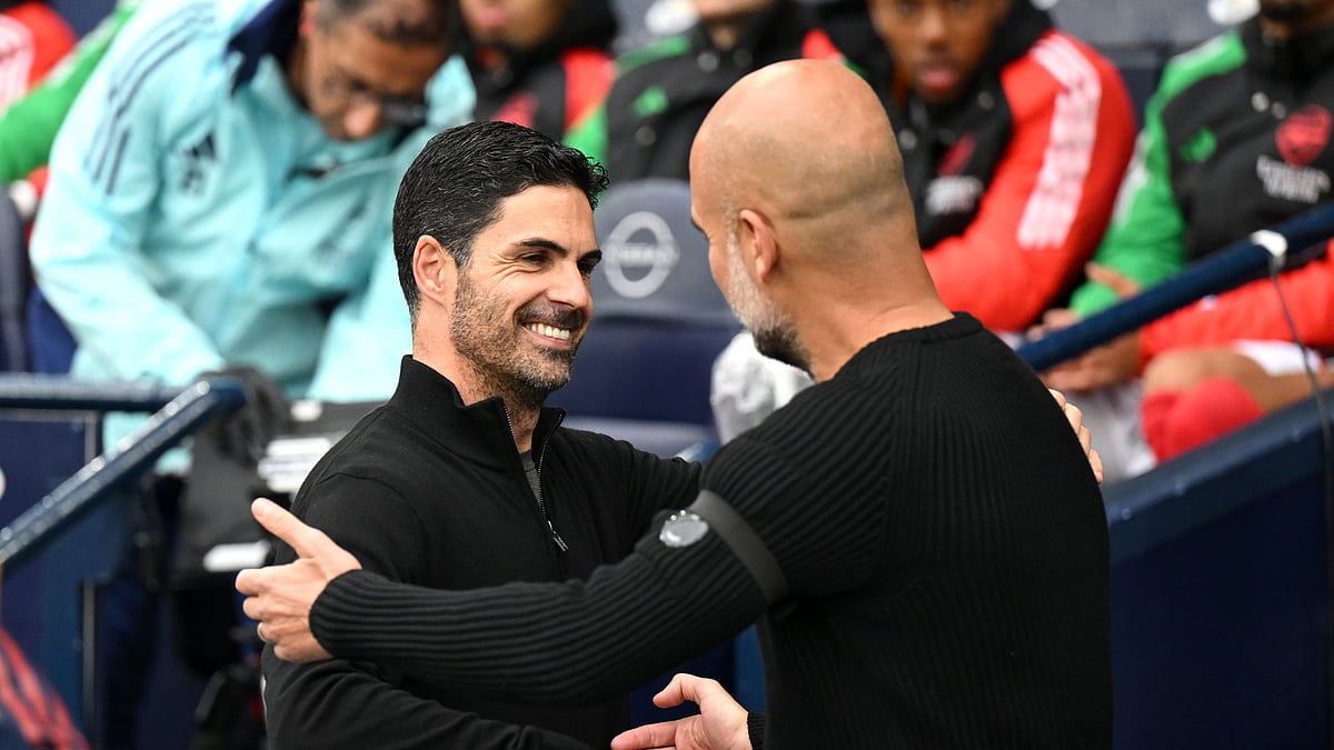 Mikel Arteta and Pep Guardiola embrace at the Etihad Stadium - null