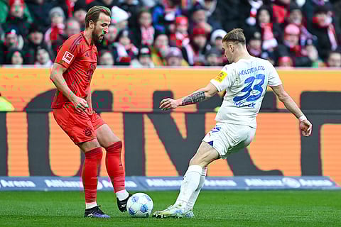 Bundesliga 2024-25: Bayern's Harry Kane and Kiel's Dominik Javorcek challenge for the ball