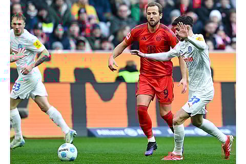 Bundesliga 2024-25: Bayern's Harry Kane and Kiel's Armin Gigovic challenge for the ball
