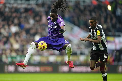English Premier League 2024-25: Fulham's Calvin Bassey and Newcastle United's Alexander Isak battle for the ball