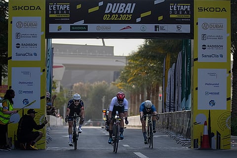 Emirates Cycling: Ibrahiem Alrefai of Syria, centre, sprints to the finish line