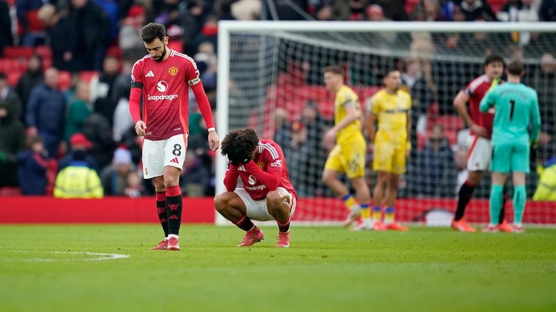 Manchester Uniteds Bruno Fernandes, left, and teammate Joshua Zirkzee react