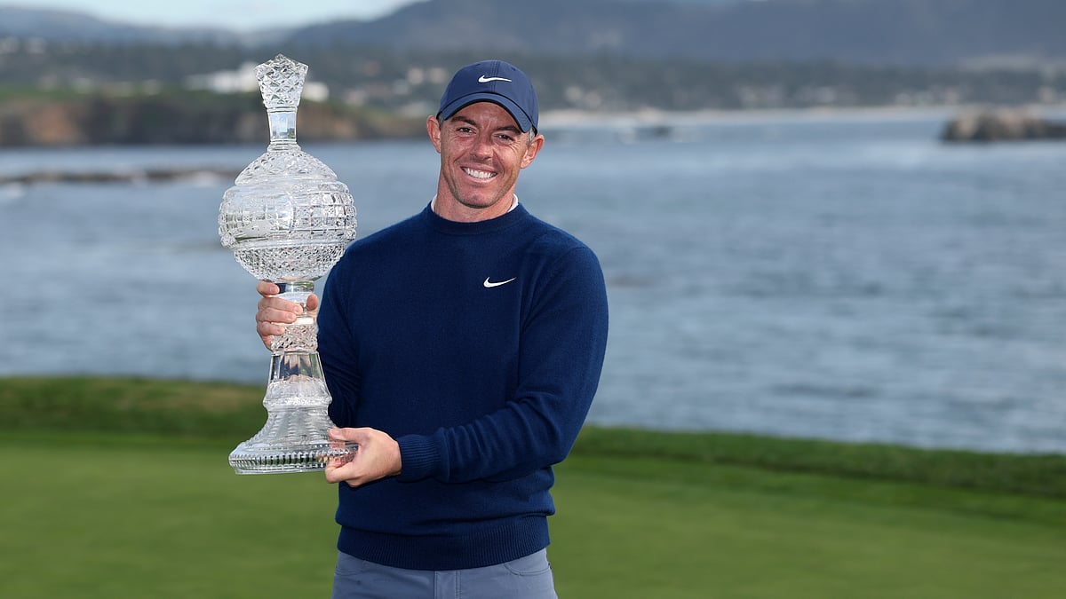 Rory McIlroy poses with the trophy after winning the Pebble Beach Pro-Am