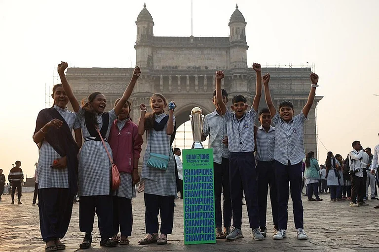 Fans pose with the trophy of ICC Men’s Champions Trophy 2025 at the Gateway of India during Trophy Tour with DP World in India - null