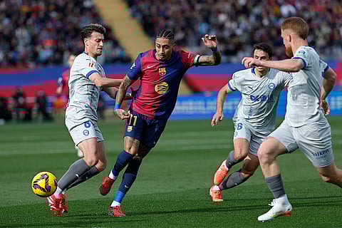 La Liga 2024-25: Barcelona's Raphinha is challenged by Alaves' Antonio Blanco