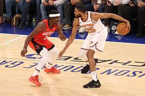 NBA 2024-25: Knicks' Mikal Bridges (25) dribbles the ball against Rockets' Aaron Holiday