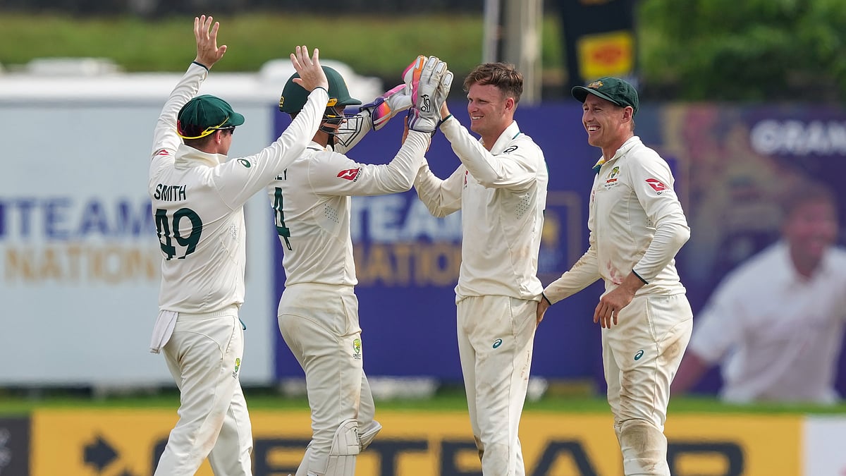 AP Photo/Eranga Jayawardena : Australia's Matthew Kuhnemann and teammates celebrate their team's win over Sri Lanka during day four of the first test cricket match between Sri Lanka and Australia in Galle.