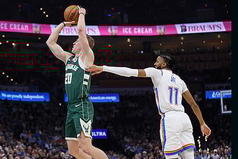 NBA 2024-25: Milwaukee guard AJ Green (20) looks to shoot in front of City guard Isaiah Joe