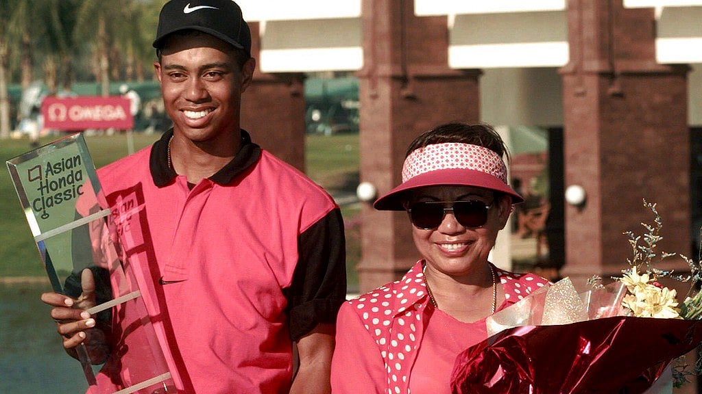 AP/File : Golf sensation Tiger Woods, left, poses with his mother Kultida while holding his trophy and key to a new car after winning the Asian Honda Classic in Bangkok.