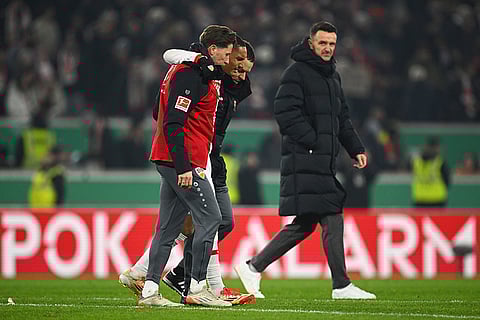 DFB-Pokal: Stuttgart's Enzo Millot, center, is helped off the pitch following an injury 