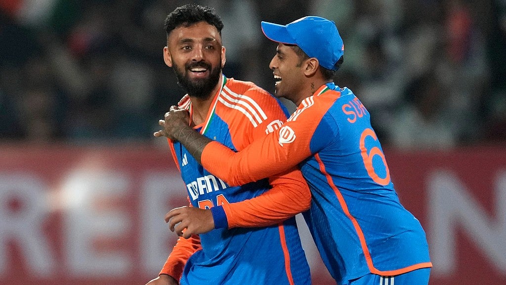 Varun Chakravarthy, left, and India captain Suryakumar Yadav