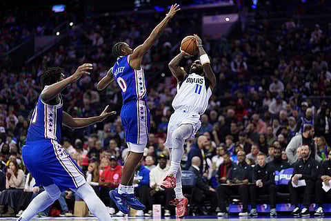 NBA 2024-25: Mavericks' Kyrie Irving goes up for a shot against 76ers' Tyrese Maxey