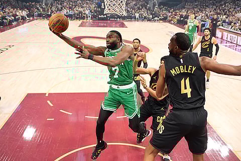 NBA 2024-25: Celtics guard Jaylen Brown (7) shoots in front of Cavaliers forward Evan Mobley