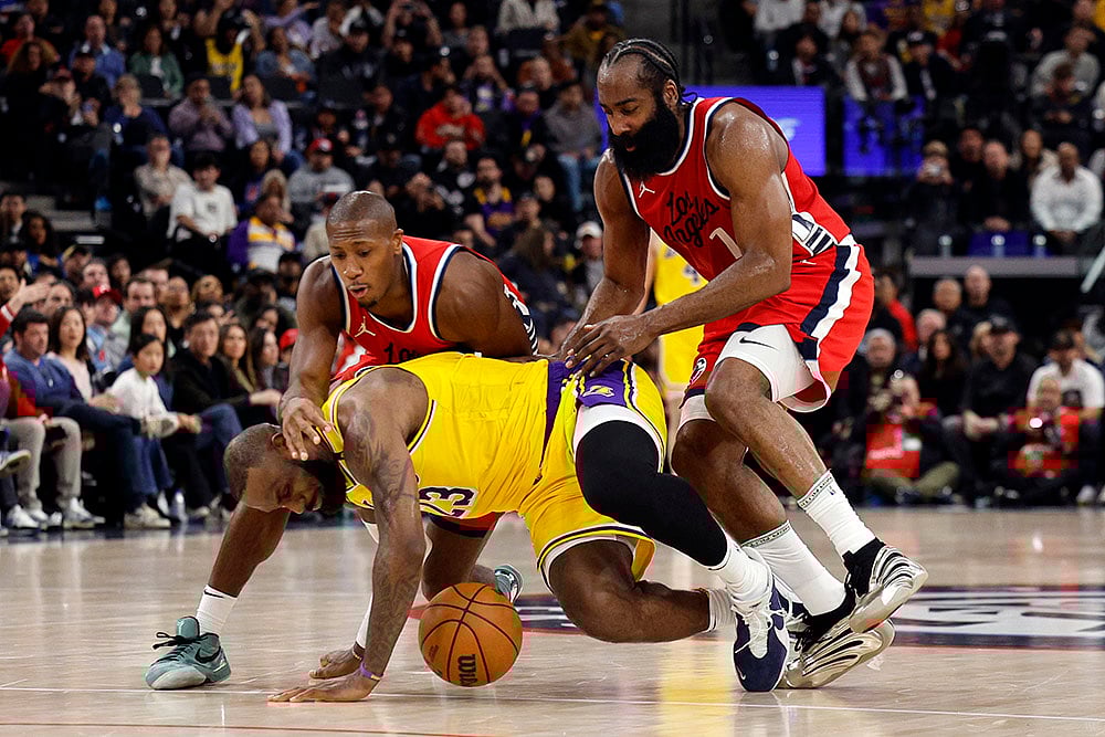 | Photo: AP/Kevork Djansezian : NBA 2024-25: Lakers LeBron James falls to the ground after a push from Clippers James Harden