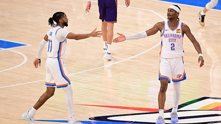 Isaiah Joe #11 and Shai Gilgeous-Alexander #2 of the Oklahoma City Thunder celebrate a play during the first half against the Phoenix Suns at Paycom Center on February 5, 2025 in Oklahoma City, Oklahoma. - null