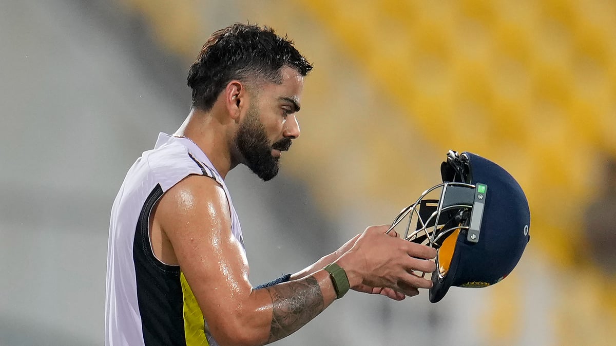 AP Photo/Aijaz Rahi : India's Virat Kohli wears his helmet to bat in the nets during a training session ahead of the first one-day international cricket match between India and England in Nagpur.