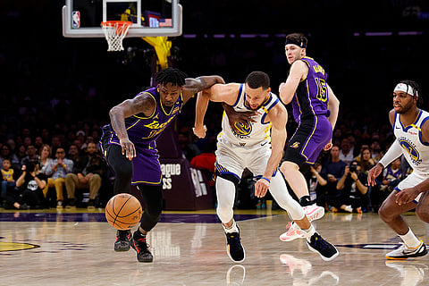 NBA 2024-25: Lakers forward Dorian Finney-Smith steals the ball from Warriors guard Stephen Curry