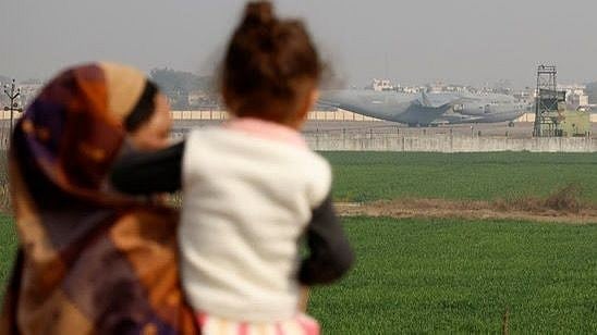| Photot-  Reuters : People look at a US military plane deporting Indian immigrants as it lands in Amritsar.
