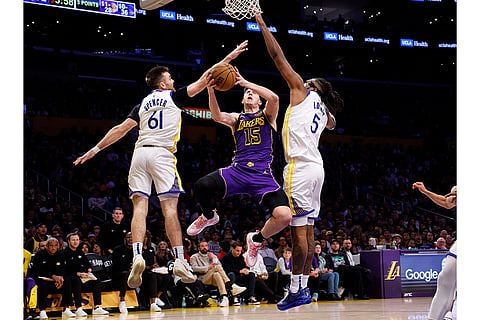 NBA 2024-25: Lakers guard Austin Reaves drives in between Warriors guard Pat Spencer and Kevon Looney