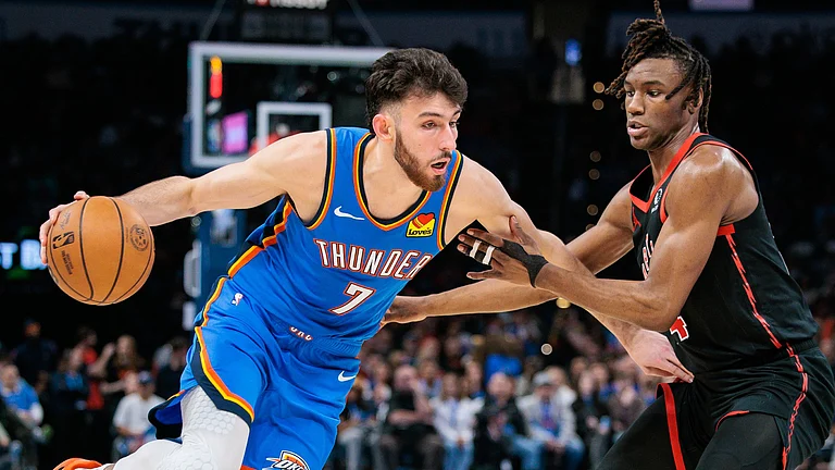 Chet Holmgren #7 of the Oklahoma City Thunder drives by Ja'Kobe Walter #14 of the Toronto Raptors during the fourth quarter at Paycom Center on February 7, 2025 in Oklahoma City, Oklahoma. - null