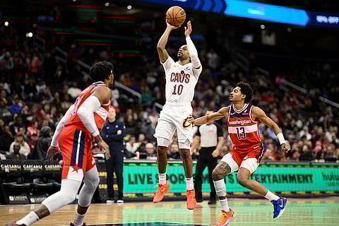 NBA 2024-25: Cavaliers guard Darius Garland (10) shoots past Wizards guard Jordan Poole