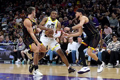 NBA 2024-25: Jazz guard Isaiah Collier (13) drives between Suns Grayson Allen (8) and Devin Booker