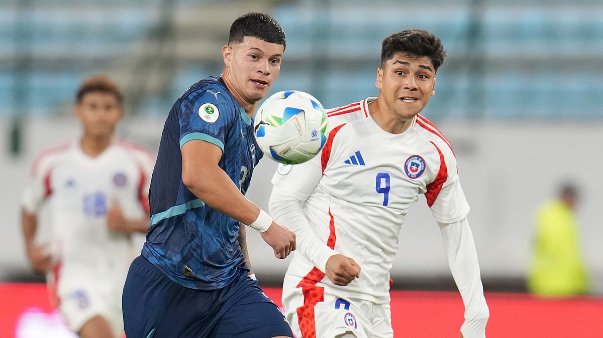 AP/Ariana Cubillos : Paraguay's Axel Balbuena, left, and Chile's Damian Pizarro pursue the ball during a South American U-20 Championship soccer match in Caracas, Venezuela, Friday, Feb. 7, 2025